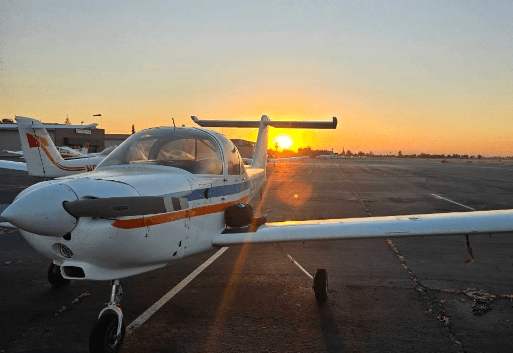 Training aircraft on the ramp at Fresno Yosemite International Airport at sunset