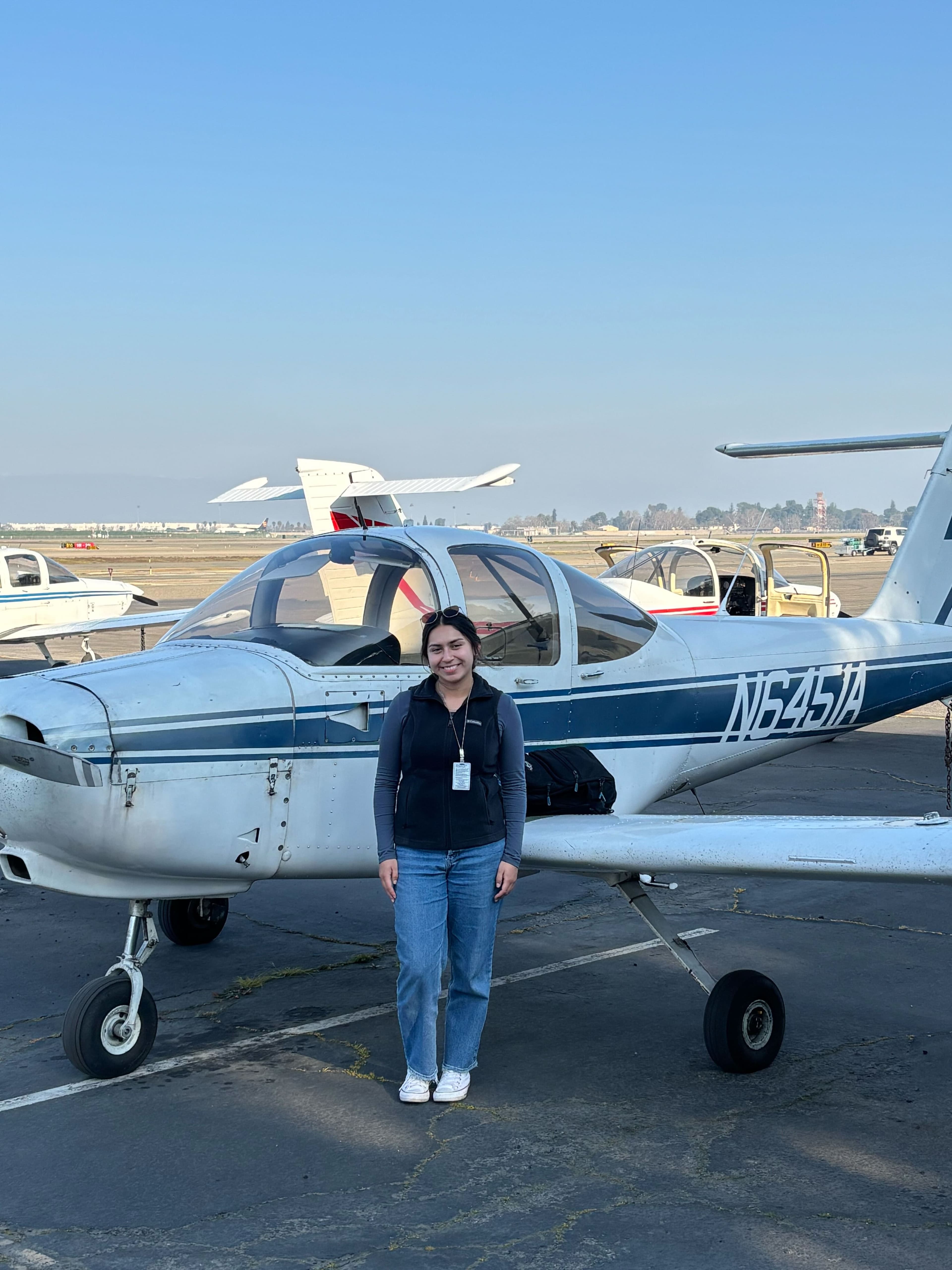 JB Aeronautics student beside a Piper Tomahawk on the ramp at KFAT