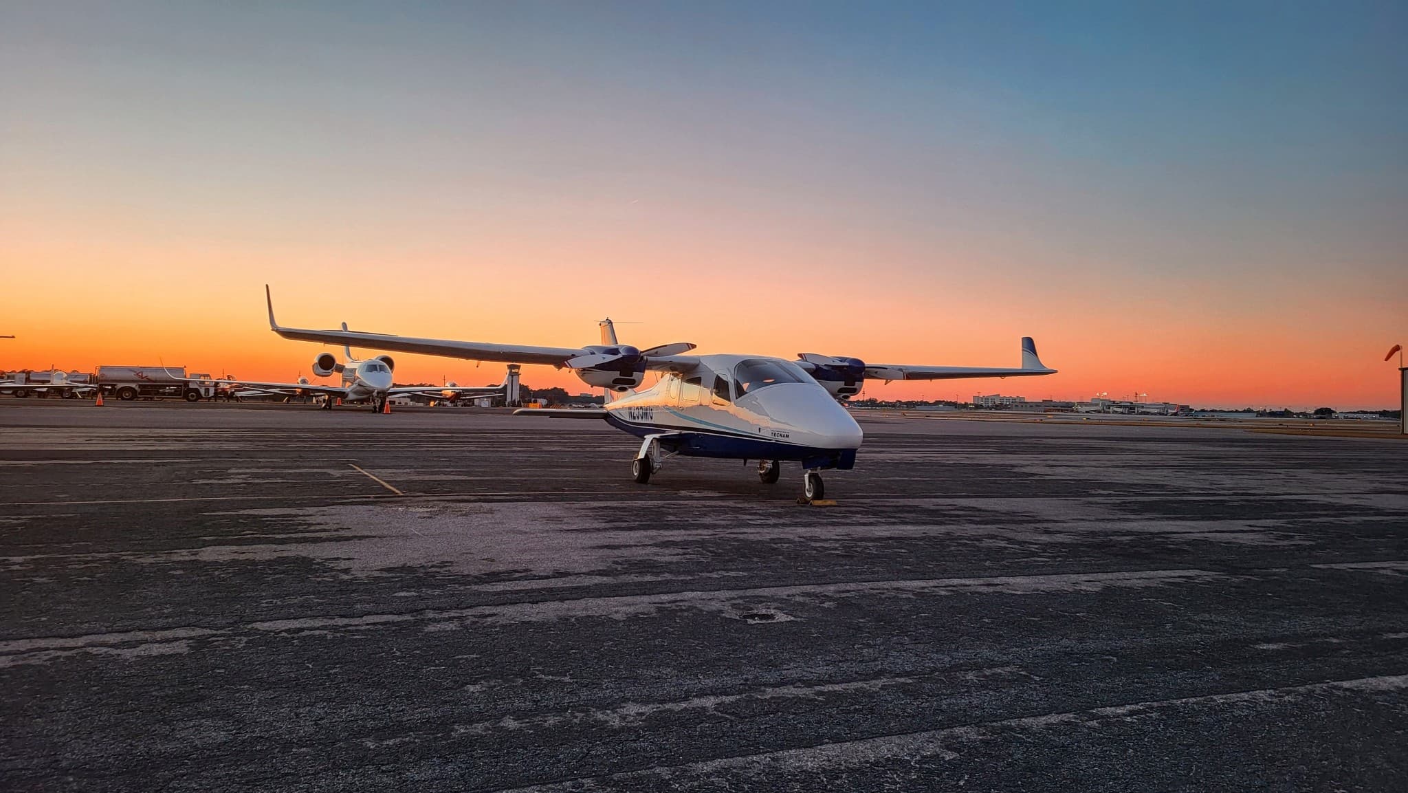 Tecnam P2006T twin-engine trainer on ramp at sunset